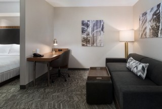 Our guest rooms feature a living area with sofa bed and work desk